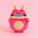 Front view of Pusheen Year of the Dragon Plush. The grey fluffy Pusheen wears a fluffy red dragon costume with gold details at the horns, whiskers, collar, and belly.