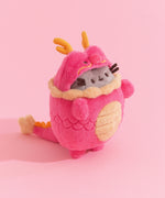 Front quarter view of the red dragon plush. Pusheen's brown whiskers extend off the front sides of the plush and can be seen from many angles.