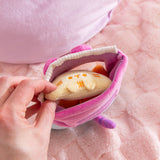 Model pulls out one light yellow tortilla chip plush from the Pusheen plush bag. The bag has a velcro closure at the top to keep the chips inside.