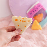 Model holds one of the yellow triangle Pusheen plush chips to show size and scale of three included plush.