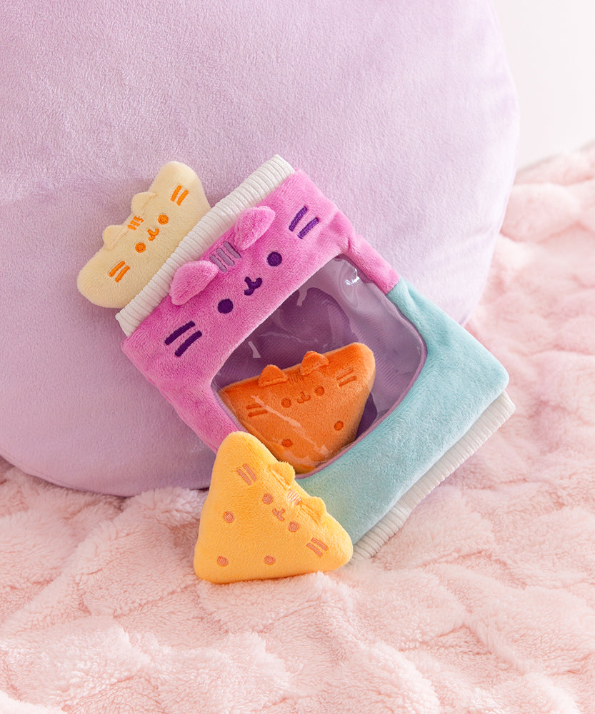 Tortilla chips inspired plush are shown within and outside of the bag of chips plush bag. 