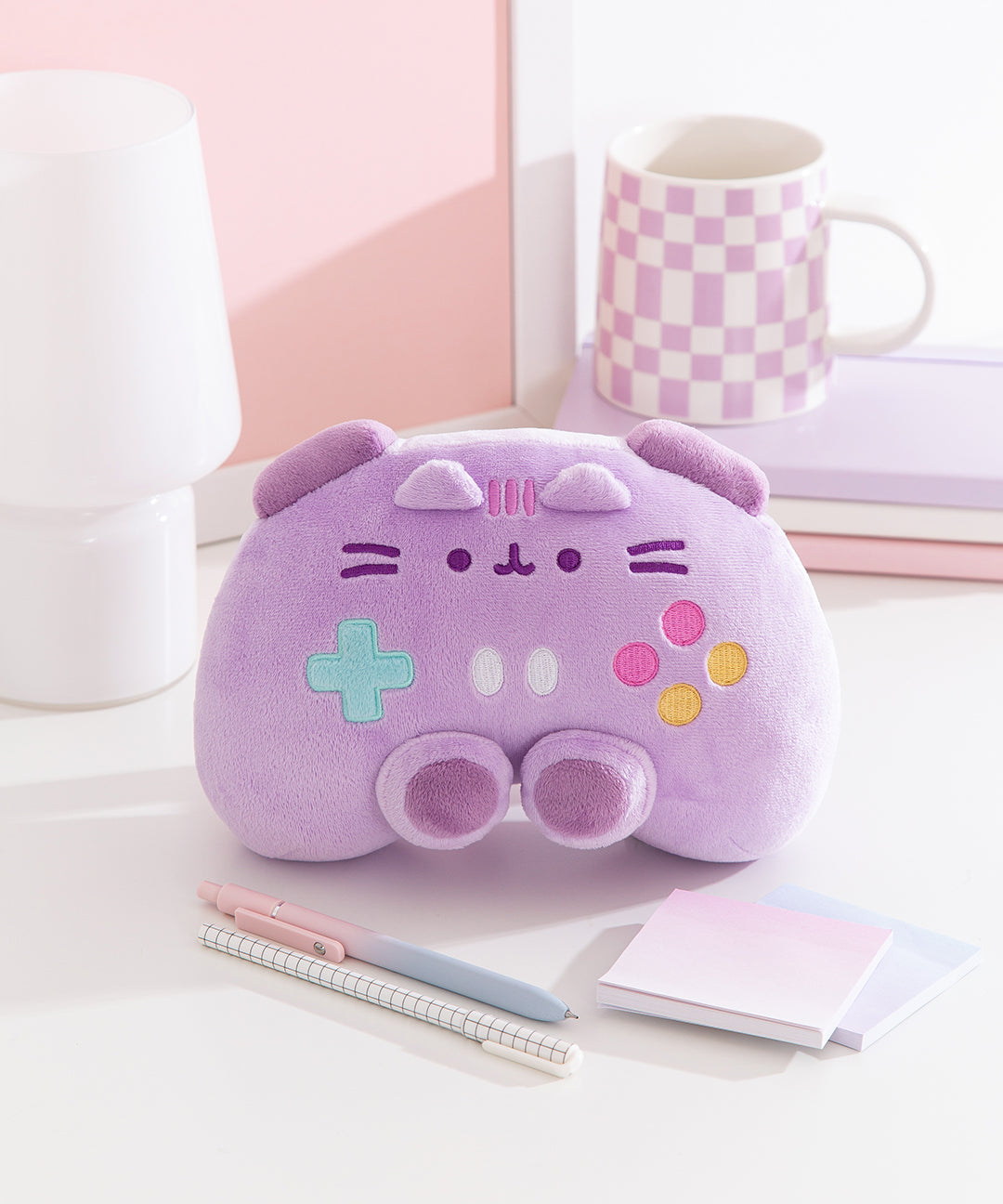 Front view of the Gamer Pusheen Controller Plush. Pusheen the Cat takes the form of a purple gaming controller including buttons and joysticks.