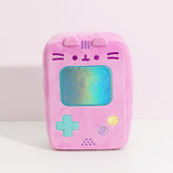Front view of the Gamer Pusheen Handheld Console Plush. Pusheen the Cat takes the form of a pink retro gaming console with a reflective blue screen, blue, yellow, and purple buttons. 