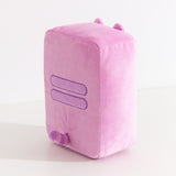 Side and back view of the Pusheen Gamer Handheld Console Plush. Pusheen's two back stripes are embroidered in purple in the middle back of the plush. Extending off the back of the plush is Pusheen's pink and purple striped tail. 