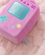 Close-up of the embroidered button details on the plush as well as the logo tag that's attached to the back bottom of the plush.