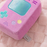 Close-up of the embroidered button details on the plush as well as the logo tag that's attached to the back bottom of the plush.