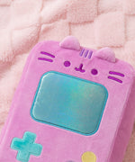 Close-up of Pusheen's face that's embroidered near the top front of the handheld plush. Pusheen's two triangle ears extend off the top front of the rectangle shaped plush. 