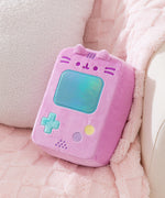 Pusheen Gamer Console Plush rests on a chair to show the size and scale of the pink gaming plush.