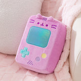 Pusheen Gamer Console Plush rests on a chair to show the size and scale of the pink gaming plush.
