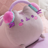 Close-up of the long gaming log plush toy. The grey cat has purple facial features embroidered on her face including eyes and mouth. Pusheen's classic three head stripes are embroidered between her two triangle shaped ears.