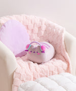 Gamer Pusheen Log Squisheen Plush sits in a chair surrounded by a pillow and blanket to show the size and scale of the oversized plush.