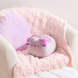 Gamer Pusheen Log Squisheen Plush sits in a chair surrounded by a pillow and blanket to show the size and scale of the oversized plush.