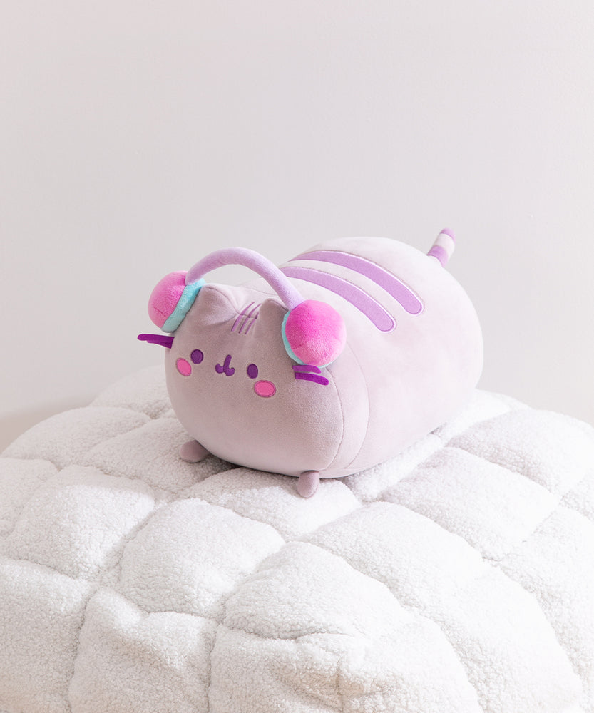 Side quarter view of the Gamer Pusheen Log Squisheen Plush. The cat's purple and gray striped tail can be seen extending off the back of the plush.