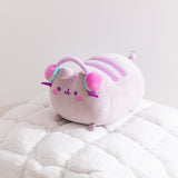 Side quarter view of the Gamer Pusheen Log Squisheen Plush. The cat's purple and gray striped tail can be seen extending off the back of the plush.