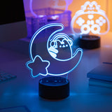 Neon light lamp shaped like a on a crescent moon with a star, glowing on a desk.