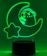 Green neon light shaped with a crescent moon, star, and Pusheen the Cat wearing headphones.