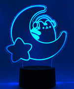 Teal neon light shaped with a crescent moon, star, and Pusheen the Cat wearing headphones.