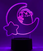 Pink neon light shaped with a crescent moon, star, and Pusheen the Cat wearing headphones.