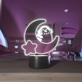Decorative night light with Pusheen on a crescent moon with a star, placed on a wooden surface.