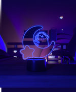 Purple LED light shaped with a crescent moon, star, and Pusheen the Cat wearing headphones.
