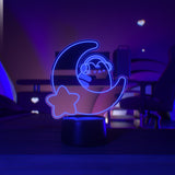 Purple LED light shaped with a crescent moon, star, and Pusheen the Cat wearing headphones.