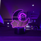 Pink LED light shaped with a crescent moon, star, and Pusheen the Cat wearing headphones.