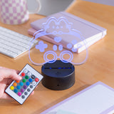 Model holds the remote to the Gamer Otaku Lamp next to the lamp to show the color and mode options.