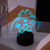 Gamer LED Lamp of Pusheen the Cat and a controller sits on a desktop in twilight.