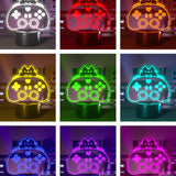Color-changing LED lamp shaped like a gaming controller with a cat design on a dark background.