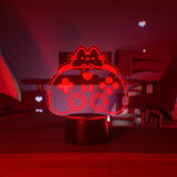 Red gaming controller-shaped light on a table with a dark background