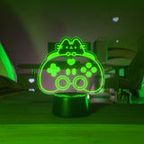 Green LED night light shaped like a gaming controller on a dark background