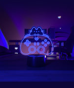 Neon sign of a cat-shaped gaming controller in a dark room.