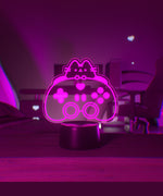 Pink LED light of Pusheen the Cat and a gaming controller.