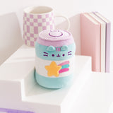 Pusheen the Cat takes the form of a blue, white, and purple energy drink can with purple facial embroidery details and a yellow, blue, purple, and pink shooting star that is embroidered on the front of the plush. 
