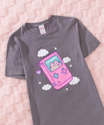 Close-up of the gray t-shirt with a large printed graphic of a gameboy style console. 