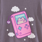 Close-up view of the gamer graphic tee. A blushing Pusheen the Cat has her paw on the blue screen of the device so you can see her pink toe beans. 