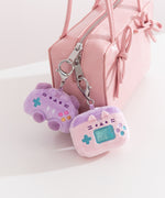 Gaming controller and switch case keychain plush are attached to zippers using their lobster claw clips affixed to the top of the plush.