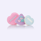 Puff trio includes three different colors and sizes. The pink puff is in the shape of a heart. The light purple puff is a triangle with a graphic of Pusheen in an envelope on the holding side. The light blue puff is a smaller heart shape than the pink puff.  