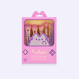 Front view of Pusheen Makeup Brush Set packaging. The pink rectangular box imitates a classic gaming device with an open window to view the tops of the 6-piece makeup brush set enclosed.   