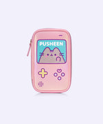 Side front view of Pusheen Makeup Brush Bag. The light pink material is reflective and has a sheen to its look. The bag features a graphic of Pusheen blushing while holding up her paw to show her pink toe beans. 