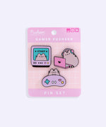 The gamer pin set is attached to a cardboard backing that is two-toned pink and has a white grid pattern in the center. At the top right of the card are three icons that mimic a browser screen. 