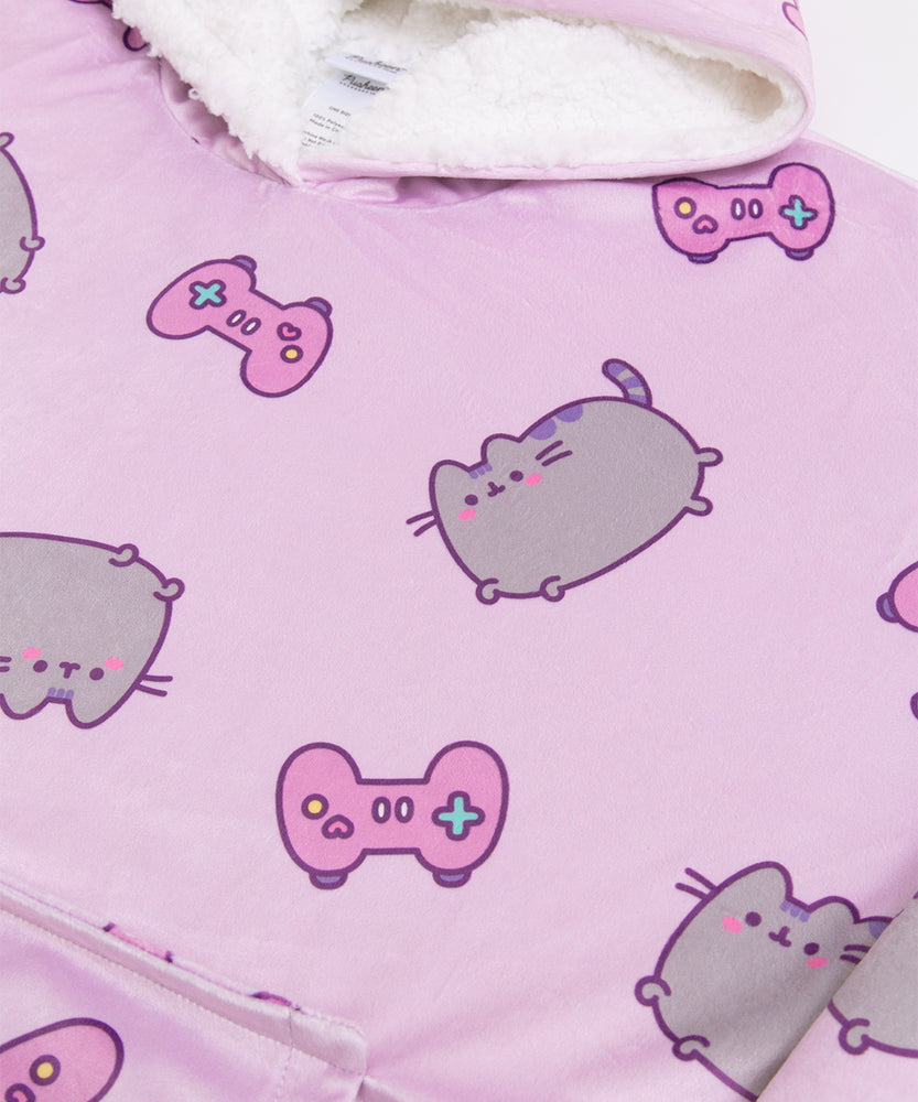 Close-up of the all-over-print on the Gamer Pusheen Wearable Blanket Hoodie. On top of the purple background are pink gaming controllers with multi-colored buttons.