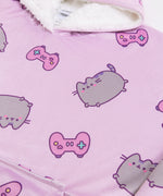 Close-up of the all-over-print on the Gamer Pusheen Wearable Blanket Hoodie. On top of the purple background are pink gaming controllers with multi-colored buttons.