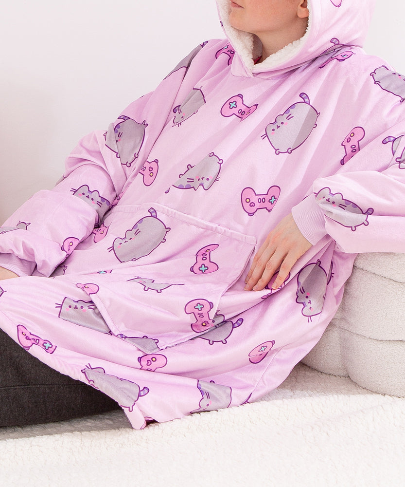 Model wearing the Wearable Blanket Hoodie. The model is reclining to show the roomy kangaroo pocket on the front of the pullover.