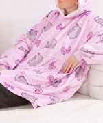 Model wearing the Wearable Blanket Hoodie. The model is reclining to show the roomy kangaroo pocket on the front of the pullover.
