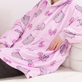 Model wearing the Wearable Blanket Hoodie. The model is reclining to show the roomy kangaroo pocket on the front of the pullover.