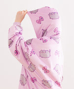 Close-up of the all-over-print on the Gamer Pusheen Wearable Blanket Hoodie. On top of the purple background are pink gaming controllers with multi-colored buttons.