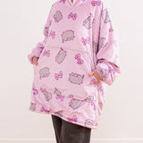 Model wears a Gamer Blanket Hoodie. With the sleeves scrunched up, the model has their hands in the front pocket to show the size and scale of the front pocket.