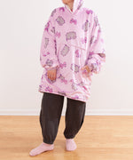 Full view of the model wearing the Gamer Wearable Blanket pullover. The oversized sweater is long and one size fits most.