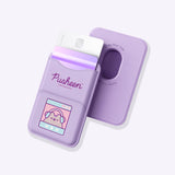 Front and back view of the purple Gaming Pusheen Magnetic Phone Wallet. The front has two pockets and a graphic of Pusheen the Cat winking while wearing headphones. The back shows an open hole in the rounded rectangular wallet so that the user can easily remove their cards from the pocket.  